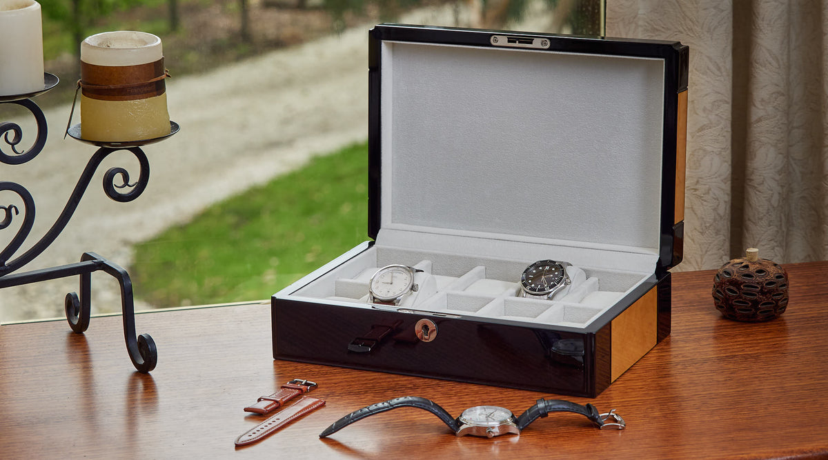 Golden oak watch box open on a timber sideboard by a garden window
